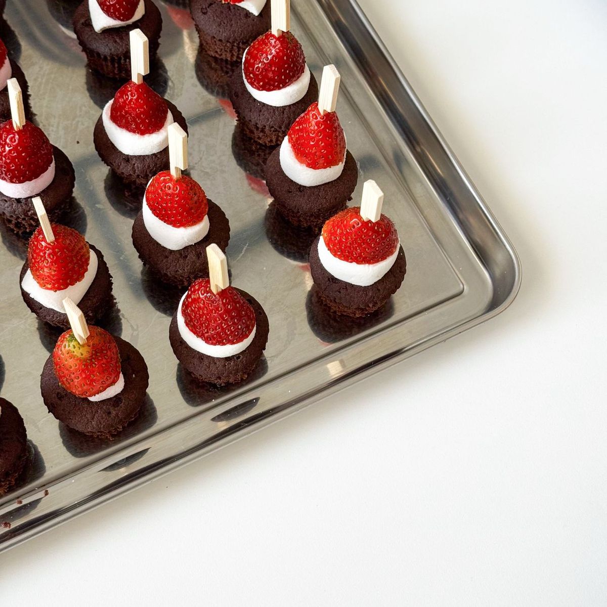 Glossy hand-dipped chocolate strawberries prepared for an event